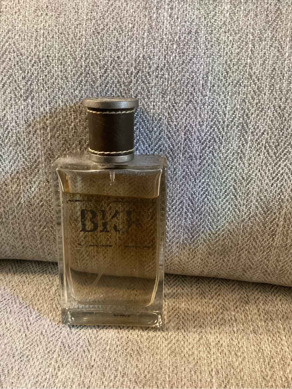 Buckle Clear Glass Cologne with Brown Liquid